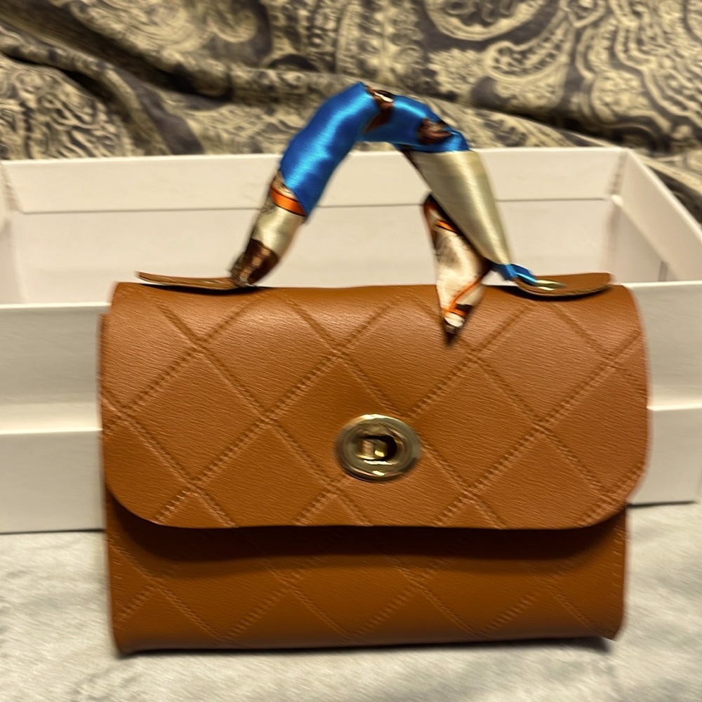 NWOT    5 inches x 7 inches petite bag.      brownish/Tannish